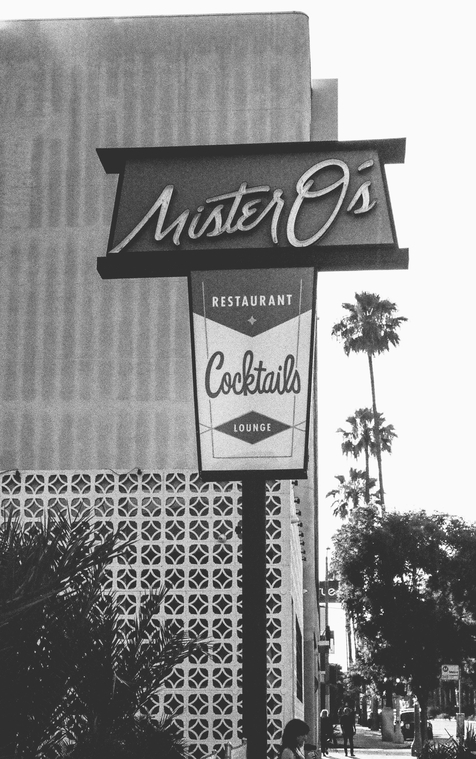 grayscale photo of UNKs coffee shop signage